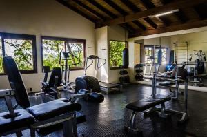 a gym with treadmills and machines in a room at Solar Mirador Exclusive Resort e SPA in Praia do Rosa