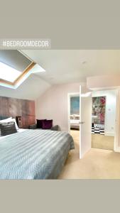 a bedroom with a bed and a room with a couch at Mrs Butler’s Mews House in Brighton & Hove