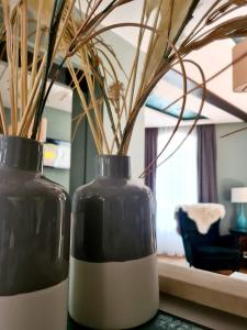 two black and white vases sitting on a table at Laci lak modern apartment in Oradea +16 photos