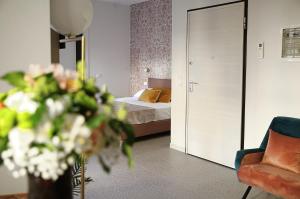 a bedroom with a bed and a vase of flowers at Romantic Verona in Verona