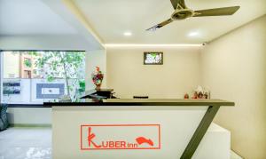 a kitchen with a counter with a ceiling fan at Treebo Trend Kuber Inn in Kharadi
