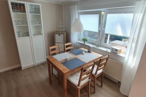 a dining room with a table and chairs and a window at fewo-grundi in Extertal