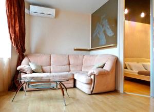 トゥーラにあるInndays Apartments Kaluzhskoe Shosseのリビングルーム(ピンクのソファ、テーブル付)