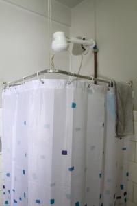 a bathroom with a shower curtain and a light at Studio no Largo da Carioca - Rio de Janeiro in Rio de Janeiro +37 photos