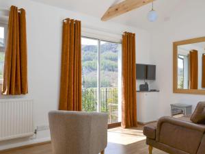 a living room with a couch and a window at Langdale Cottage in Chapel Stile