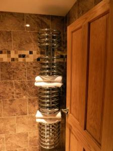 a bathroom with a stack of towels in a shower at Hewlett Apartments in Cheltenham