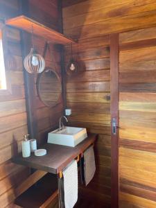 a bathroom with a sink and a mirror at Pousada Wind Rose in Itarema