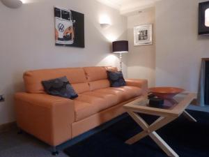 a living room with a couch and a table at Hewlett Apartments in Cheltenham