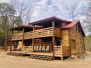 a log cabin with chairs in front of it at Lodge at Bradley Mtn in Townsend