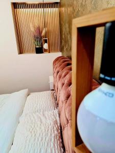 a bedroom with a bed with a mirror and a table at Laci Lak Premium apartment in Oradea