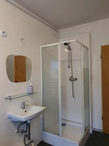 a bathroom with a shower and a sink at Märkischer Hof Hotel in Berlin