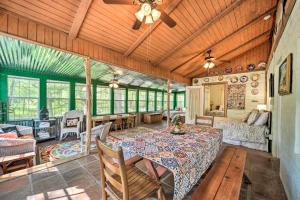 a living room with a table and a couch at Wimberley Home on Creek and Close to Downtown! in Wimberley +32 photos