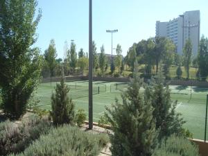 a couple of tennis courts in a park at Troia Residence by The Editory - Apartamentos Marina in Troia