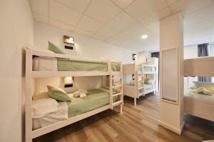 a room with three bunk beds in it at ALBERGUE SEGUE O CAMIÑO in Sigüeiro