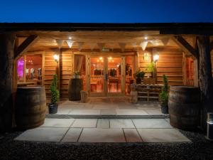 a front door of a log cabin at night at Lodge 7 - The Earn in Perth