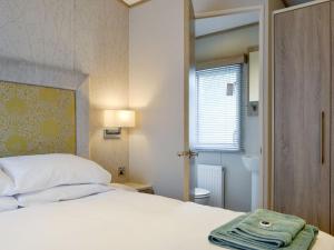 um quarto com uma cama com uma toalha em Tranquil Lodge - Uk35277 em Brigham