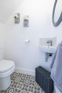 a white bathroom with a toilet and a sink at Cleethorpes Holiday Home SLEEPS 6 in Cleethorpes