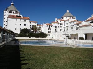 a large building with a swimming pool in front of it at Porto Marina @Vilamoura in Vilamoura