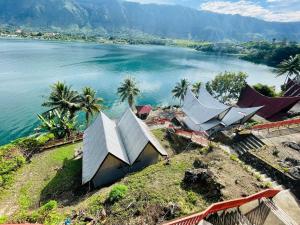 an aerial view of a house next to a body of water at Vandu's View Guest house & Restaurant in Tuk Tuk