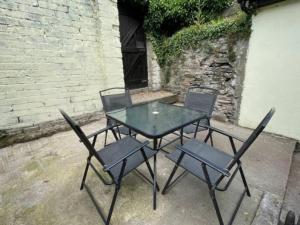 a table and four chairs sitting next to a building at Acushla House in Londonderry County Borough