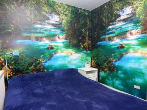 a bedroom with a mural of a river at Apartment, guest in Güster