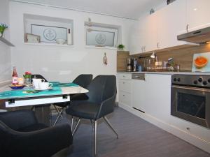 a kitchen with a table and chairs in a room at Apartment, guest in Güster