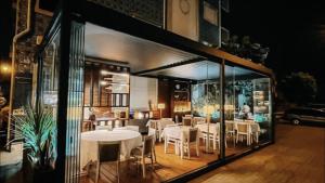 a dining room with white tables and chairs at Diamante Azul Barra Beach Apartment in Praia da Barra