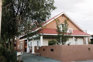 a house with a red roof on a street at The Parador in Santa Fe