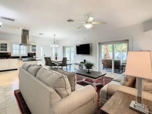 ein Wohnzimmer mit einer Couch und Stühlen und einem Tisch in der Unterkunft STEPS FROM THE BEACH, BEST LOCATION, 2 BDRM 2 BTH in Clearwater Beach