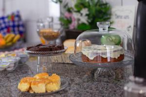 a counter with two plates of pastries and a bowl of desserts at HOTEL MORADA DO SOL in Pontal do Paraná