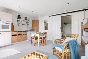 a kitchen and dining room with a table and chairs at Kragerø hytte havsutsikt in Kragerø