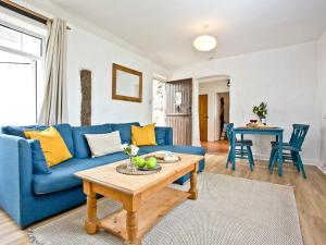 a living room with a blue couch and a table at Granary - Uk31175 in Saint Martin