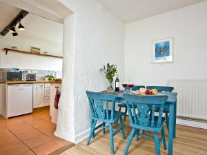 a blue table in a kitchen with blue chairs at Granary - Uk31175 in Saint Martin