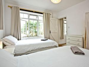 a bedroom with two beds and a window at Granary - Uk31175 in Saint Martin