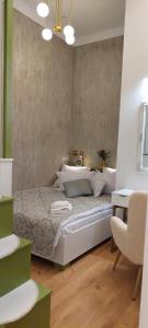 a bedroom with a bed and a chair at Apartament M Vatra Dornei in Vatra Dornei