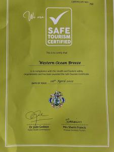 a green envelope with a safe tourism certified sign at Western Ocean Breeze Self Catering in Victoria