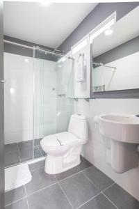 a bathroom with a toilet and a sink and a shower at Bianco Hotel Boutique in Cúcuta