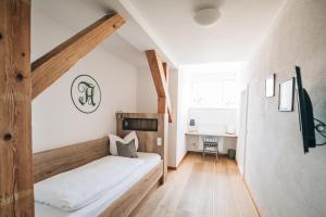 a bedroom with a bed and a desk at Angermühle Landgasthof in Altenmarkt an der Alz