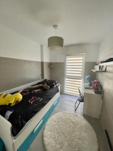 a bedroom with a bed and a rug and a window at Appartement coquet in Marseille