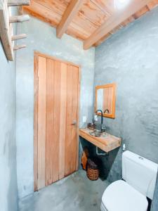 a bathroom with a toilet and a sink at Caramuru Hostel Caraíva in Caraíva