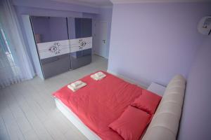 a bedroom with a bed with red sheets and pillows at Antonelya Home in Sapanca