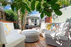 a patio with two wicker couches and a table at Mi Corazon Hot Tub Walk to River Yoga Studio in Guerneville