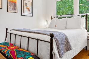 a bedroom with a bed and a window at Mi Corazon Hot Tub Walk to River Yoga Studio in Guerneville