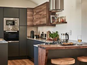 a kitchen with wooden cabinets and a counter top at Hill Street in Colne