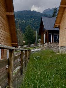 a wooden fence in front of a house at Villa Pax in Peje +7 photos
