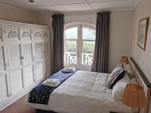 a bedroom with a large bed and a window at 20 Montego Bay - Caribbean Estates in Port Edward