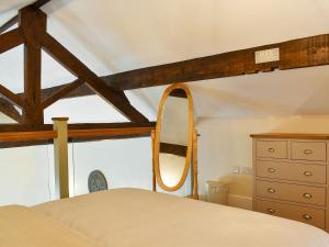 a bedroom with a bed with a mirror and a dresser at Swallow Barn in Hargrave