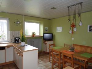 a kitchen with a table and a dining room at Gîte Fischer in Ottrott