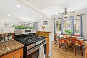 a kitchen with a stove and a dining room at Bright & Cozy Getaway-10min to Downtown LA in Alhambra