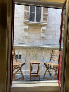 a view of a table and chairs from a window at Valletta Home -Dar il-Kavallier Jacques de Quiqueran in Valletta